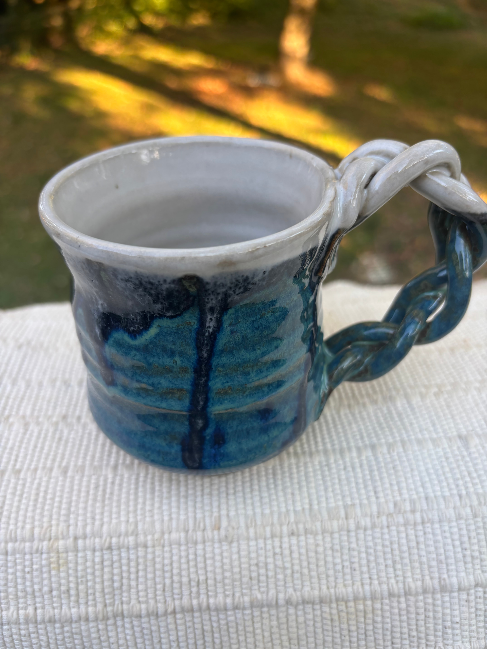 mug with braided handle
deep green with white rim and interior
n/a